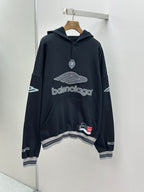 Balenciaga navy pullover hoodie with front logo and hood, ribbed hem