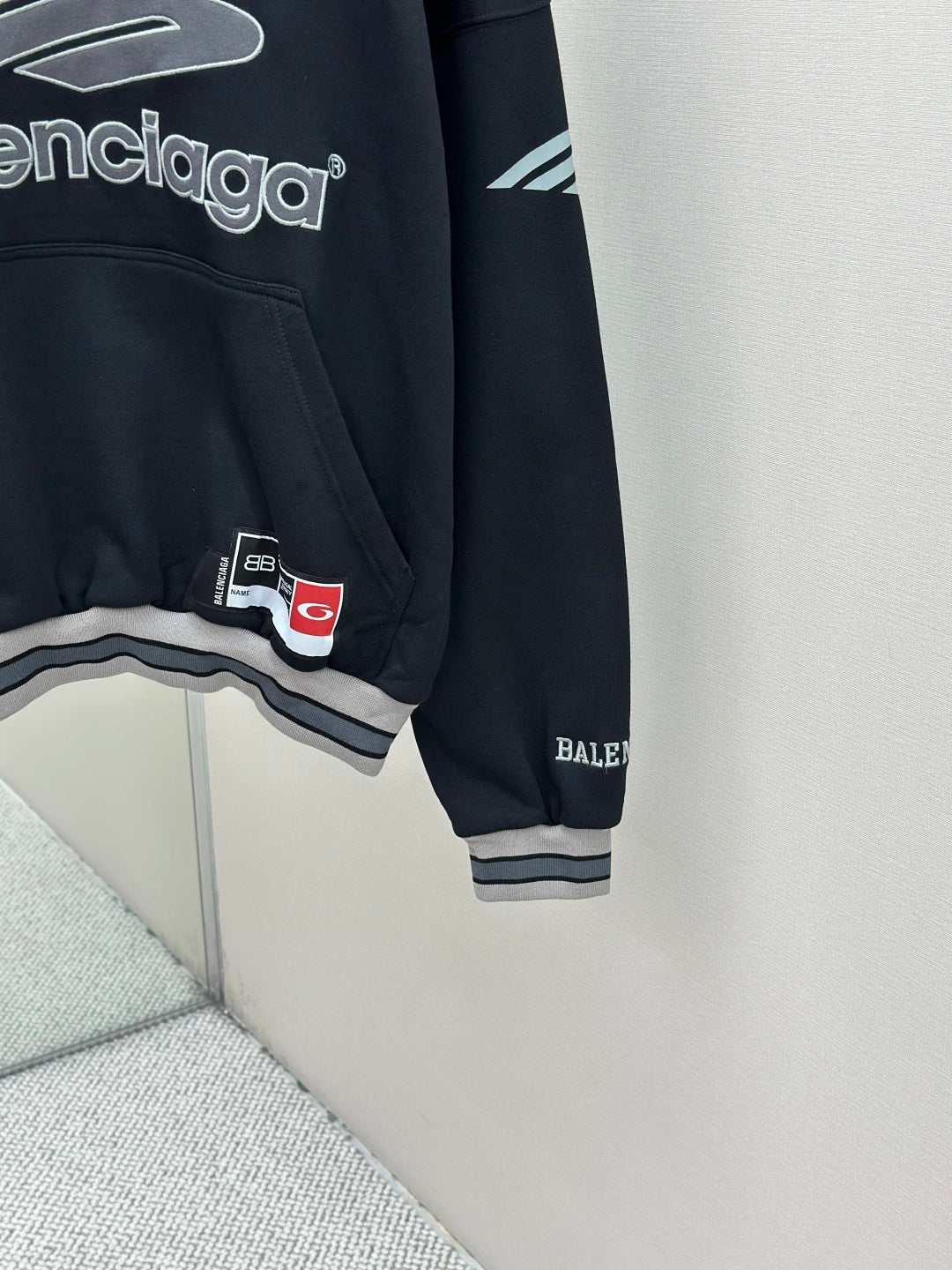 Balenciaga navy pullover hoodie sleeve with logo patch and ribbed cuff