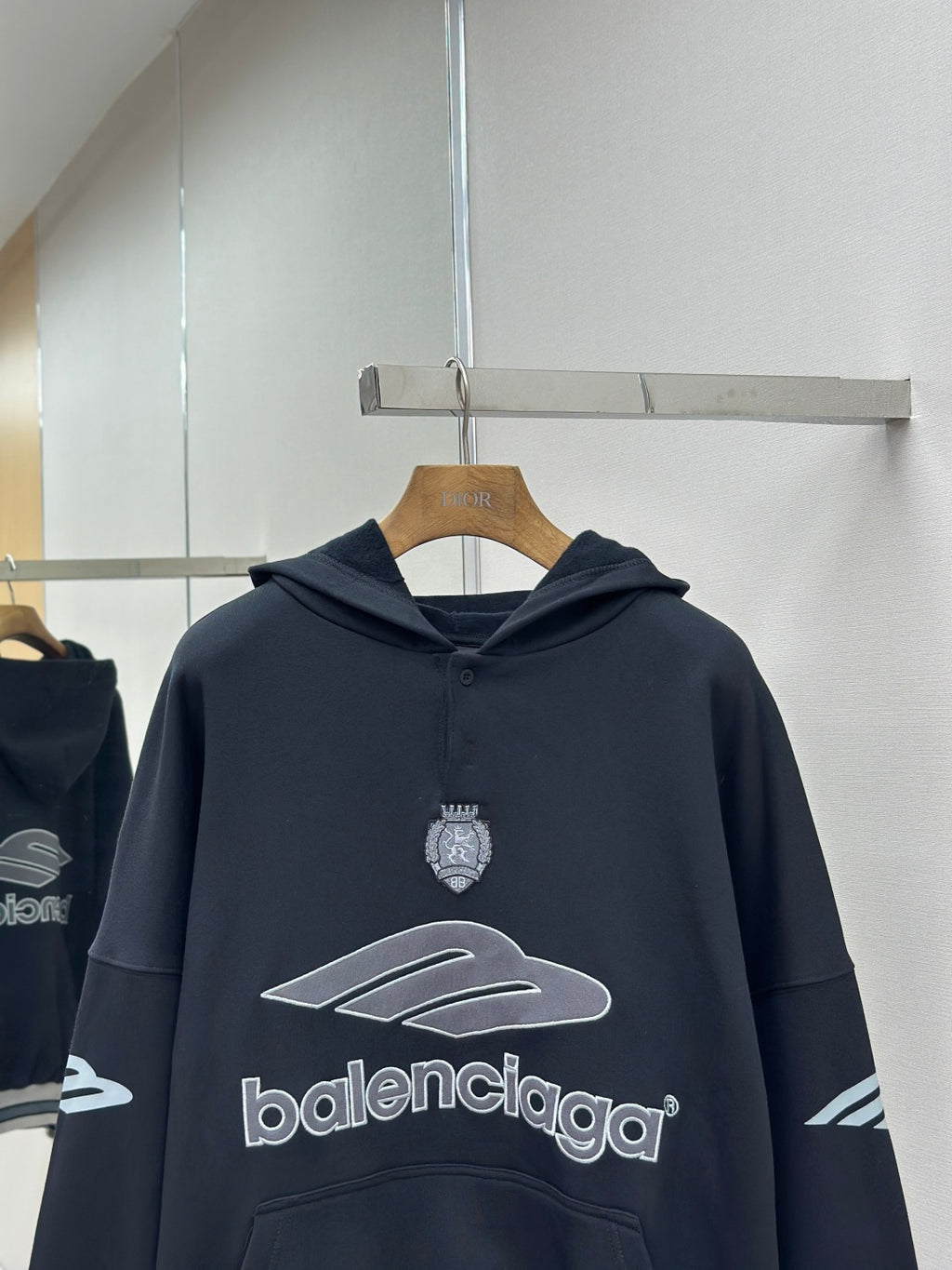 Balenciaga navy pullover hoodie with chest crest, graphic emblem and hood