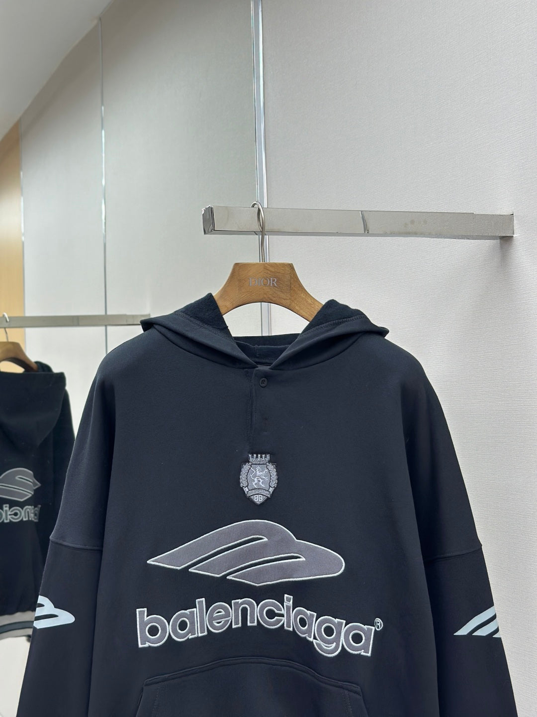Balenciaga navy pullover hoodie with chest crest, graphic emblem and hood