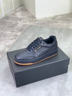 Unisex dark navy lace-up sneakers on a shoebox with light tan rubber sole