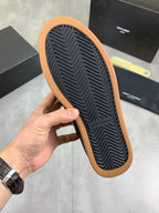 Unisex dark navy sneaker outsole with ribbed tread and tan rubber border