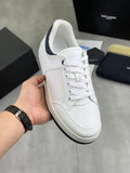 White low-top sneakers with navy collar trim and lace-up front