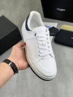 White low-top sneakers with navy collar trim and lace-up front