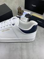 White low-top sneakers with navy inner lining and low profile rubber sole