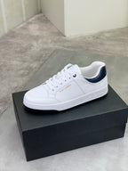 White low-top sneakers with navy-lined collar and lace-up front