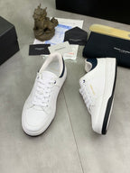 White low-top sneakers with navy heel panel and rubber outsole
