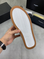 Unisex low-top sneakers outsole: textured tread, white with brown rubber edge.