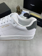 Unisex low-top sneakers close-up: white padded collar, gray side panel.