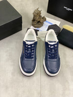 Pair of navy sneakers with white midsoles and blue lace-up front, SAINT LAURENT