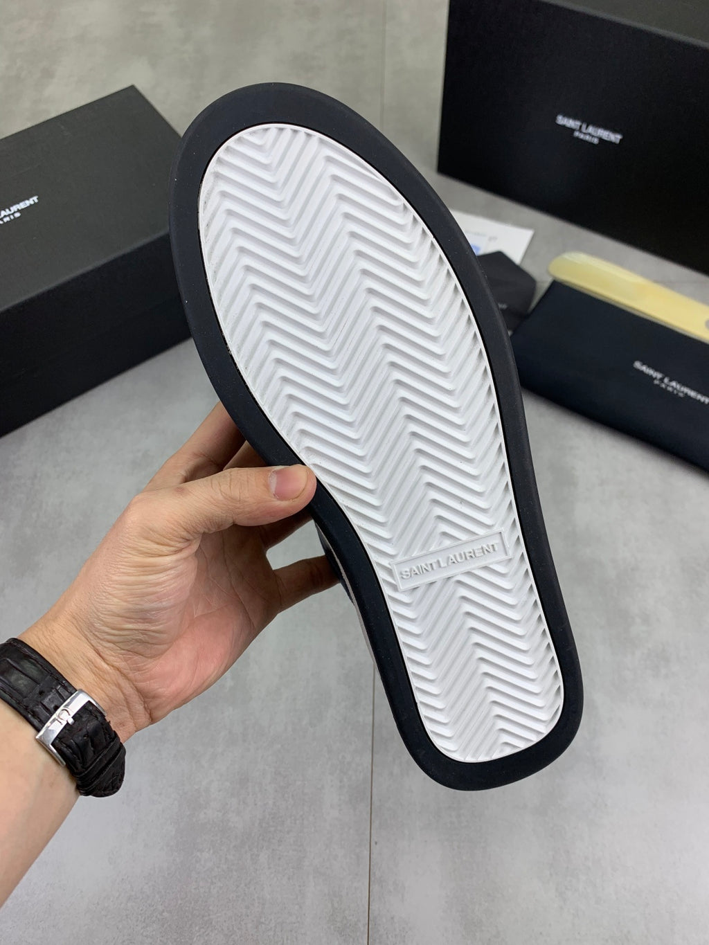 Shoe outsole view: white tread with dark rubber edge, SAINT LAURENT