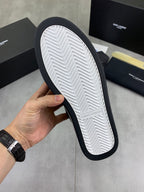 Shoe outsole view: white tread with dark rubber edge, SAINT LAURENT