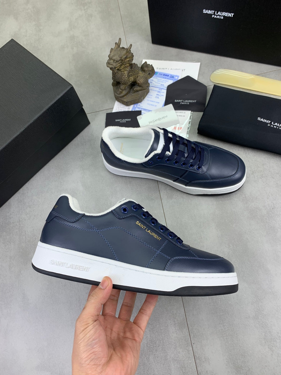 Navy sneakers with white midsoles and lace-up design, SAINT LAURENT on tongue