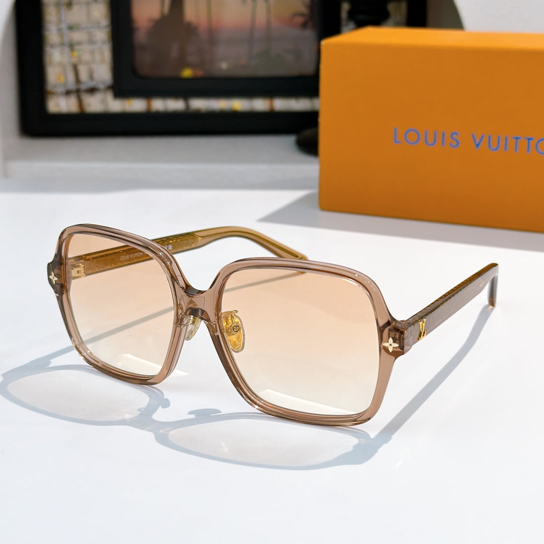 Louis Vuitton sunglasses, translucent brown frame with amber gradient lenses and gold star