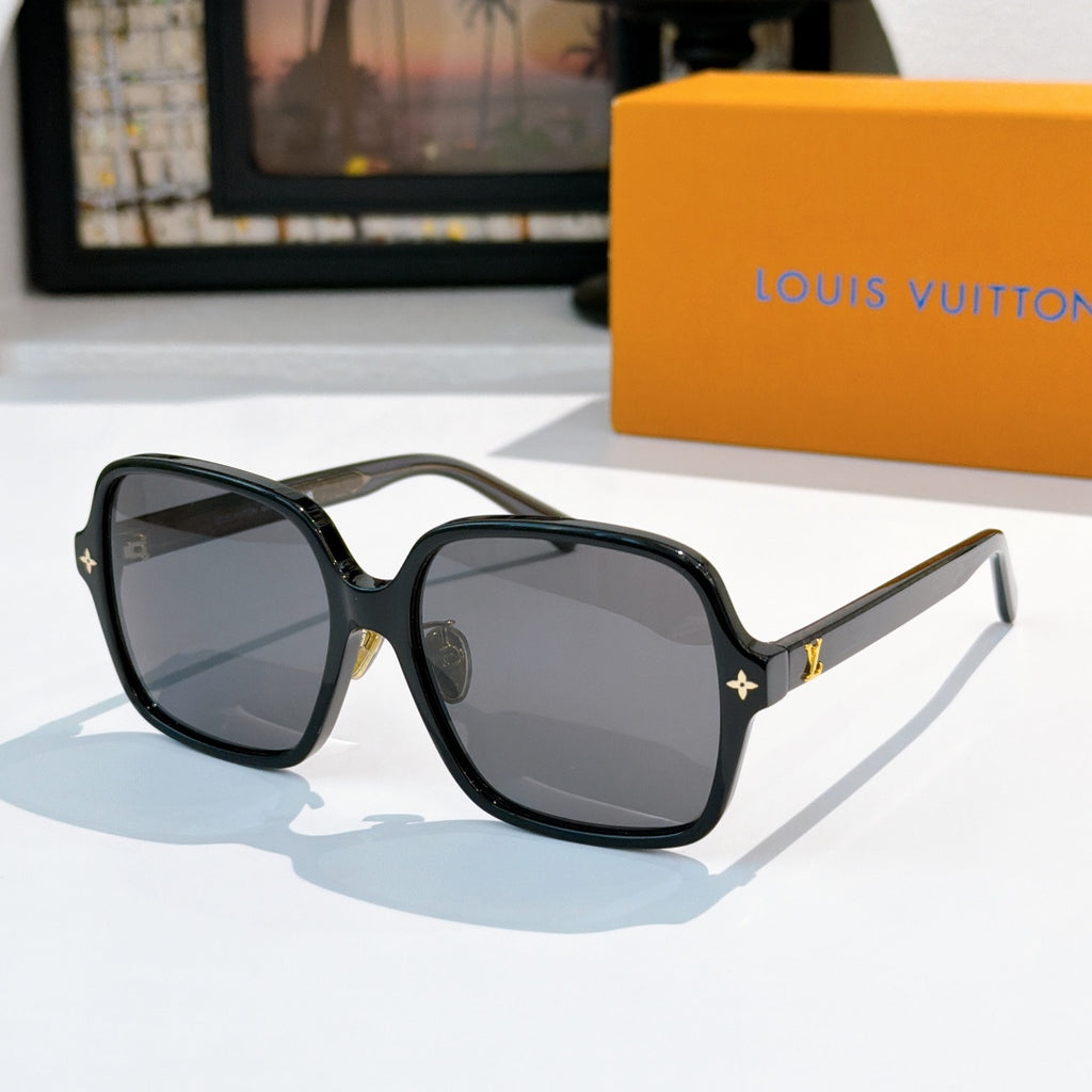 Louis Vuitton sunglasses, dark frame with dark gray lenses and gold star detail