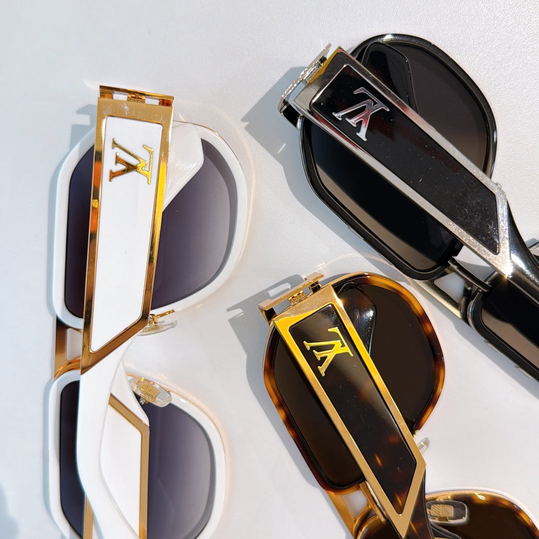 Louis Vuitton sunglasses close-up showing black, white, and tortoiseshell frames