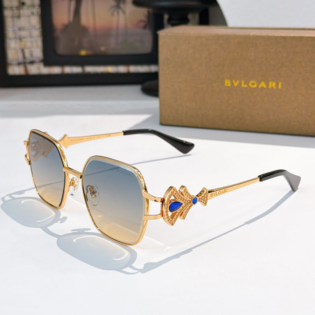 Bvlgari sunglasses with gold frame, blue-tinted lenses, ornate jewel temple detail