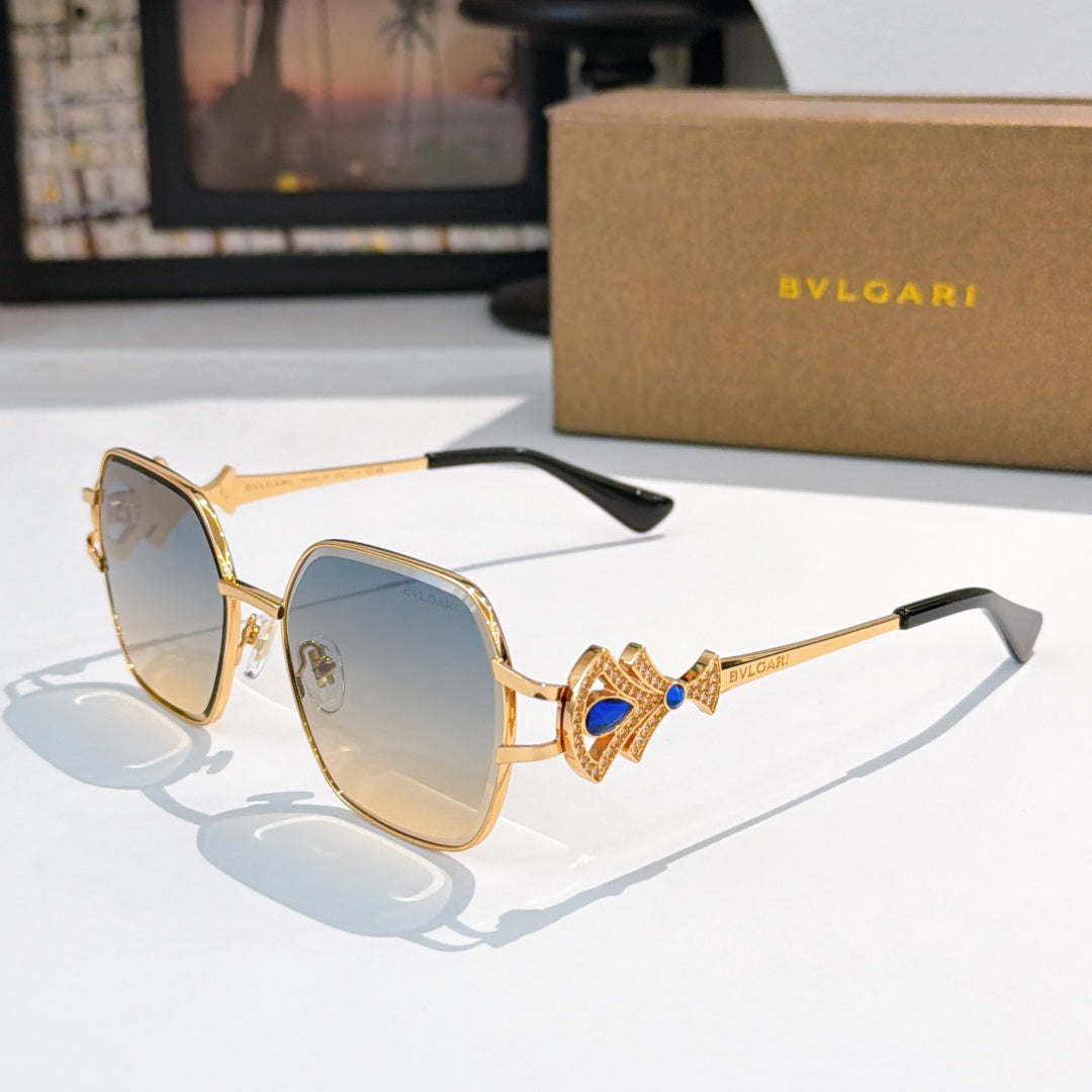 Bvlgari sunglasses with gold frame, blue-tinted lenses, ornate jewel temple detail