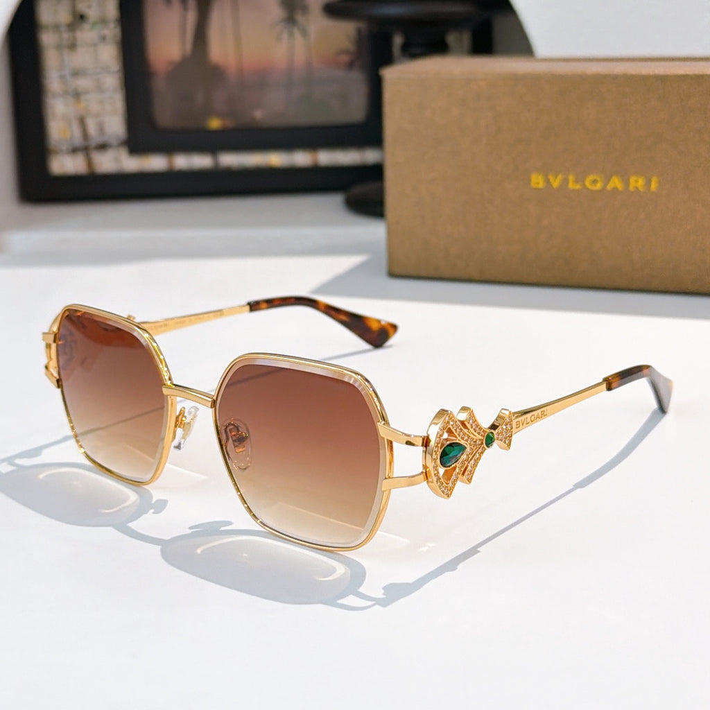 Bvlgari sunglasses with gold frame, warm brown tinted lenses, green gem temple detail