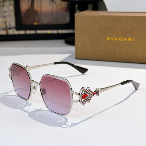 Bvlgari sunglasses with silver frame, pink tinted lenses, jeweled red center charm