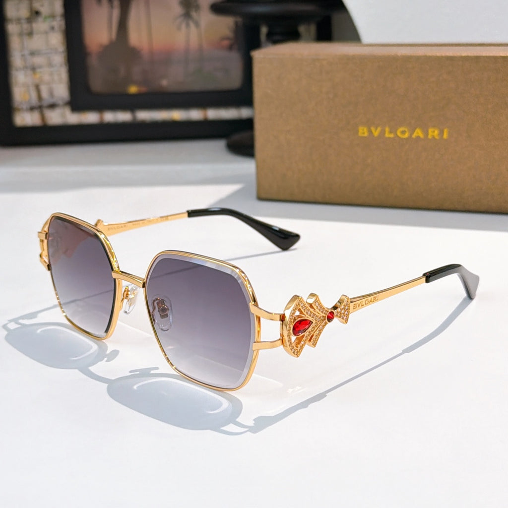 Bvlgari sunglasses with gold frame, purple tinted lenses, red jewel temple detail