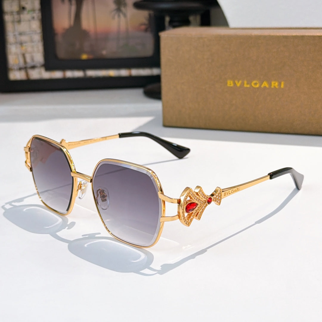 Bvlgari sunglasses with gold frame, purple tinted lenses, red jewel temple detail
