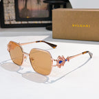 Bvlgari sunglasses with gold frame, amber tinted lenses, blue gem ornate temple