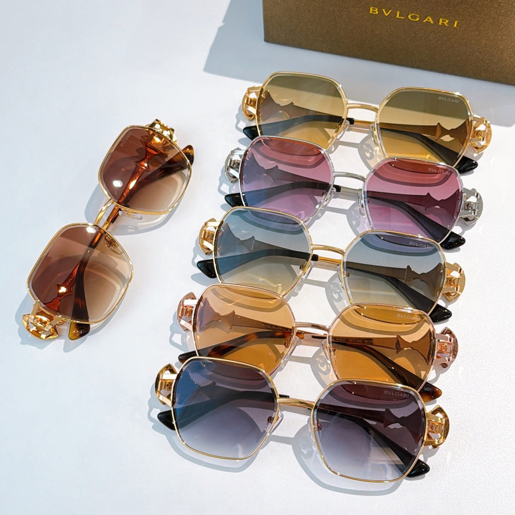 Bvlgari sunglasses set with gold frames and tinted lenses, ornate temple charms