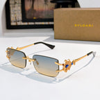 Bvlgari gold-tone sunglasses with light blue gradient lenses and ornate bar temples