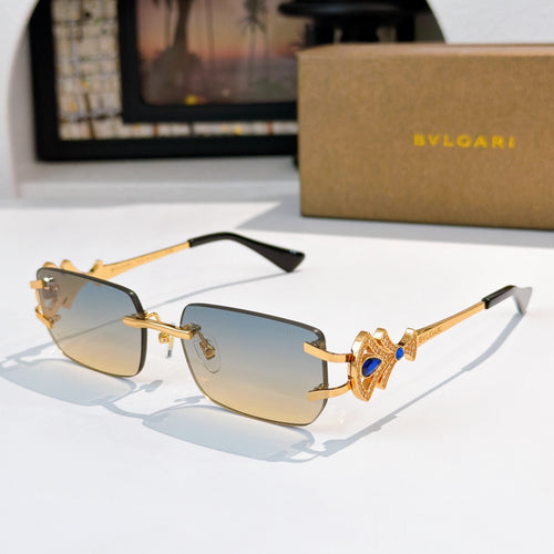 Bvlgari gold-tone sunglasses with light blue gradient lenses and ornate bar temples