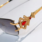 Bvlgari close-up sunglasses with gold jeweled frame and red stone temple detail
