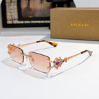 Bvlgari gold-tone sunglasses with brown gradient lenses and blue gem temple detail