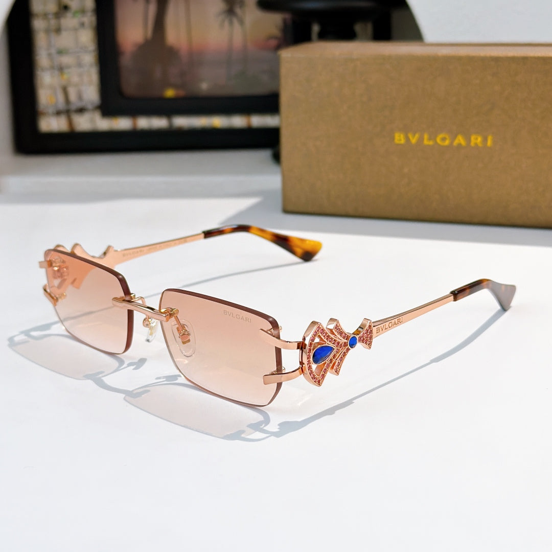 Bvlgari gold-tone sunglasses with brown gradient lenses and blue gem temple detail