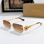 Bvlgari gold-tone sunglasses with amber lenses and ornate green gem temple detail