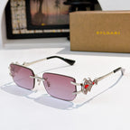 Bvlgari gold-tone sunglasses with pink lenses and jeweled red temple detail