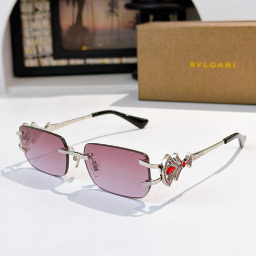 Bvlgari gold-tone sunglasses with pink lenses and jeweled red temple detail