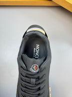 Moncler sneaker close-up of tongue and collar, dark navy with brand patch and laces
