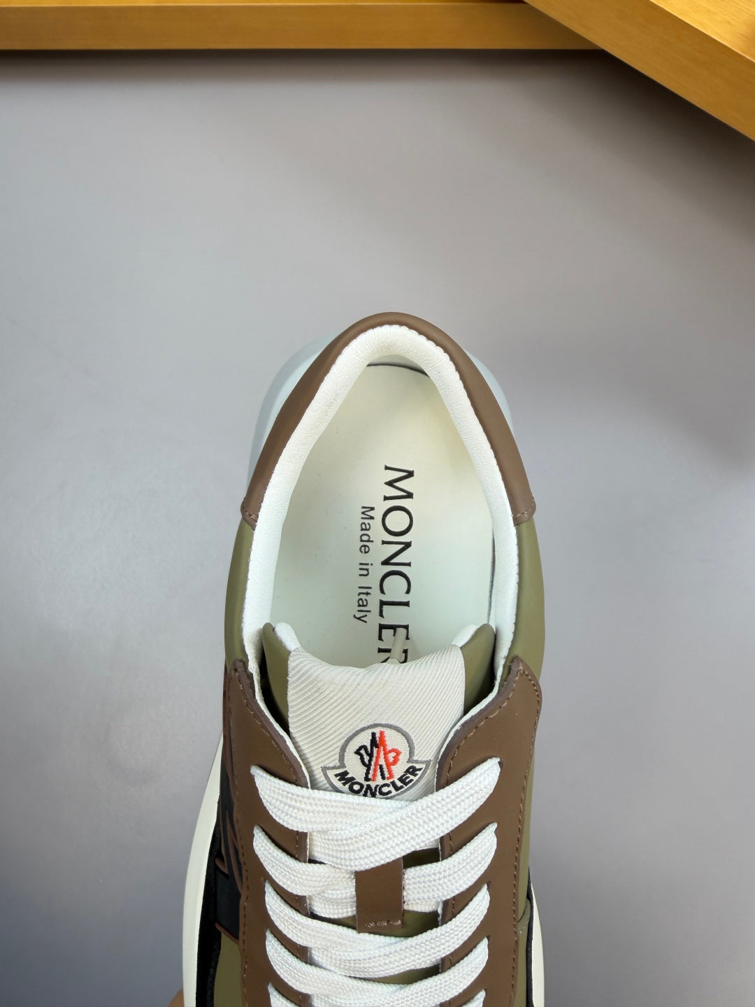 Sneaker interior and tongue label; white lining with brown trim and laces.