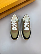 Sneakers, olive and black uppers with white laces, viewed from above.