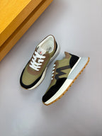 Sneakers with olive and black panels, white laces, and cream side trim.