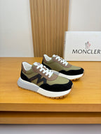 Sneakers with olive, black, and cream panels, white laces, low-profile sole.
