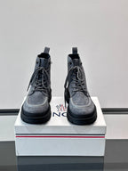 Moncler pair of lace-up ankle boots on white box; dark blue suede and chunky rubber sole