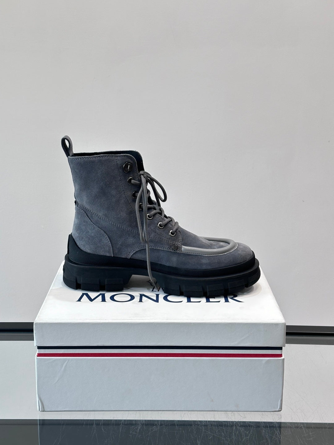 Moncler lace-up ankle boots on box, dark blue suede with round toe and treaded sole