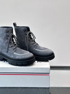 Moncler lace-up ankle boots close angle; dark blue suede, gray laces, chunky lug sole