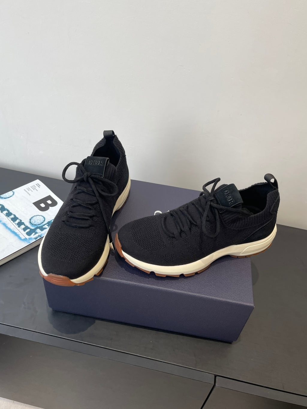 Black knit lace-up sneakers with Dior-stamped tongue and low sole profile