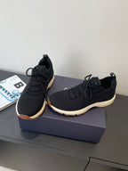 Black knit lace-up sneakers with Dior-stamped tongue and low sole profile