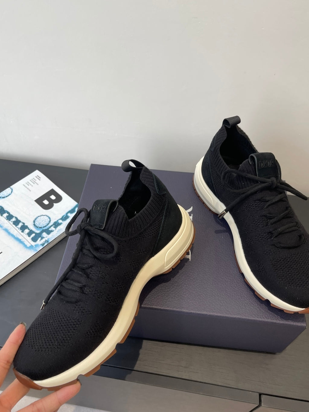 Black knit sneakers with lace-up front and chunky white midsole