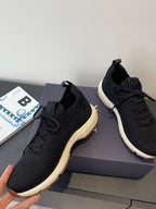 Black knit sneakers with lace-up front and chunky white midsole