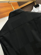 Long-sleeve button-up shirt in dark black, upper back with shoulder yoke seam