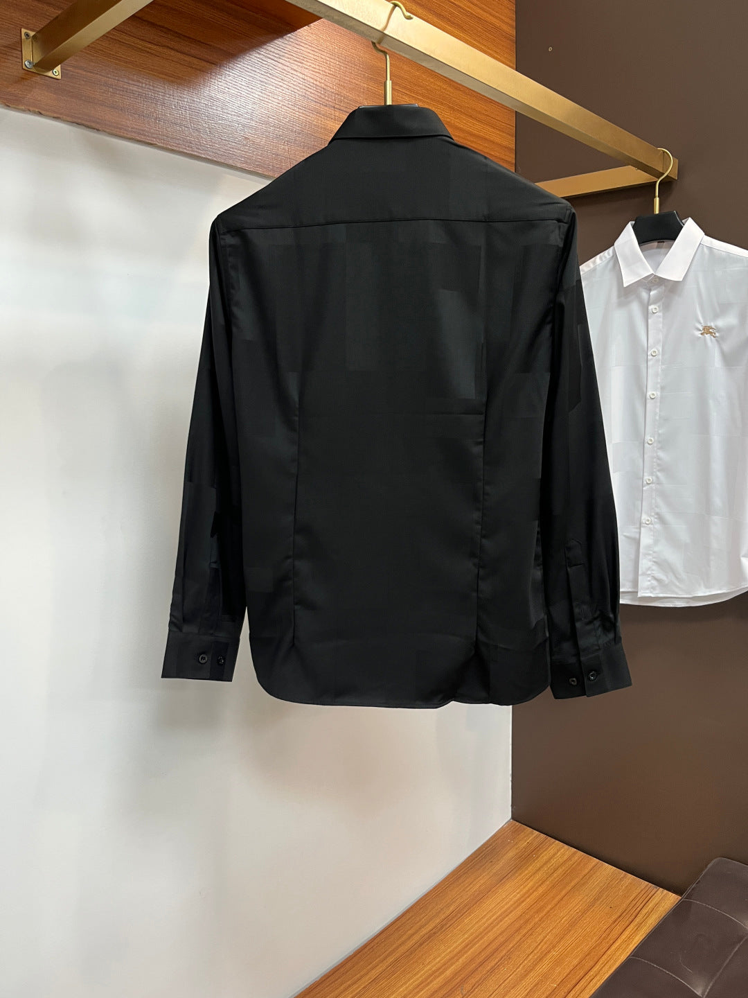 Long-sleeve button-up shirt, dark black, back view with center seams and collar